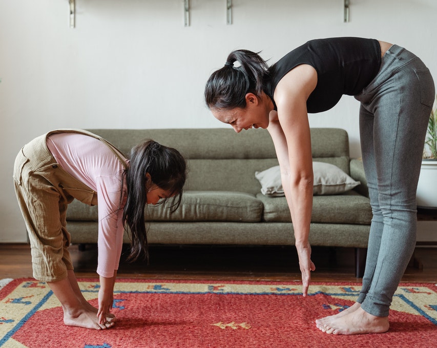 Mum and young daughter exercising