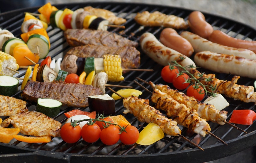 Barbeque Food Including Sausages Chicken Kebabs And Tomatoes